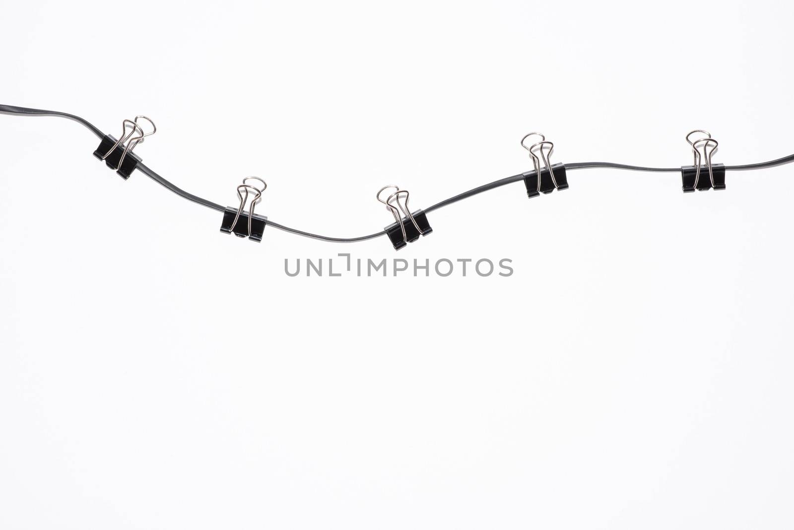 office paper clips on rope isolated on white by elina_chernikova