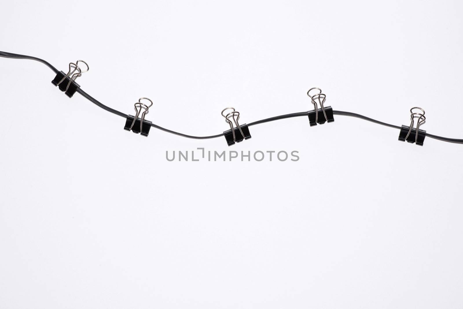 office paper clips on rope isolated on white