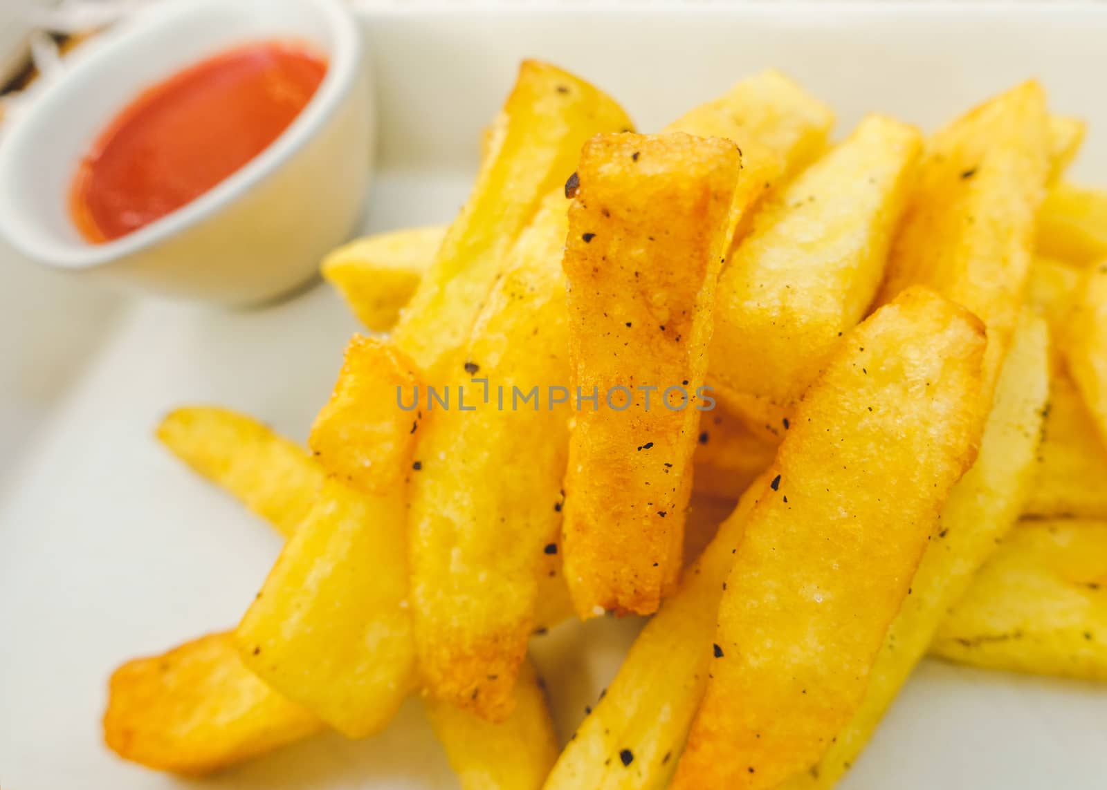 Closeup of chips on a plate and tomato sauce