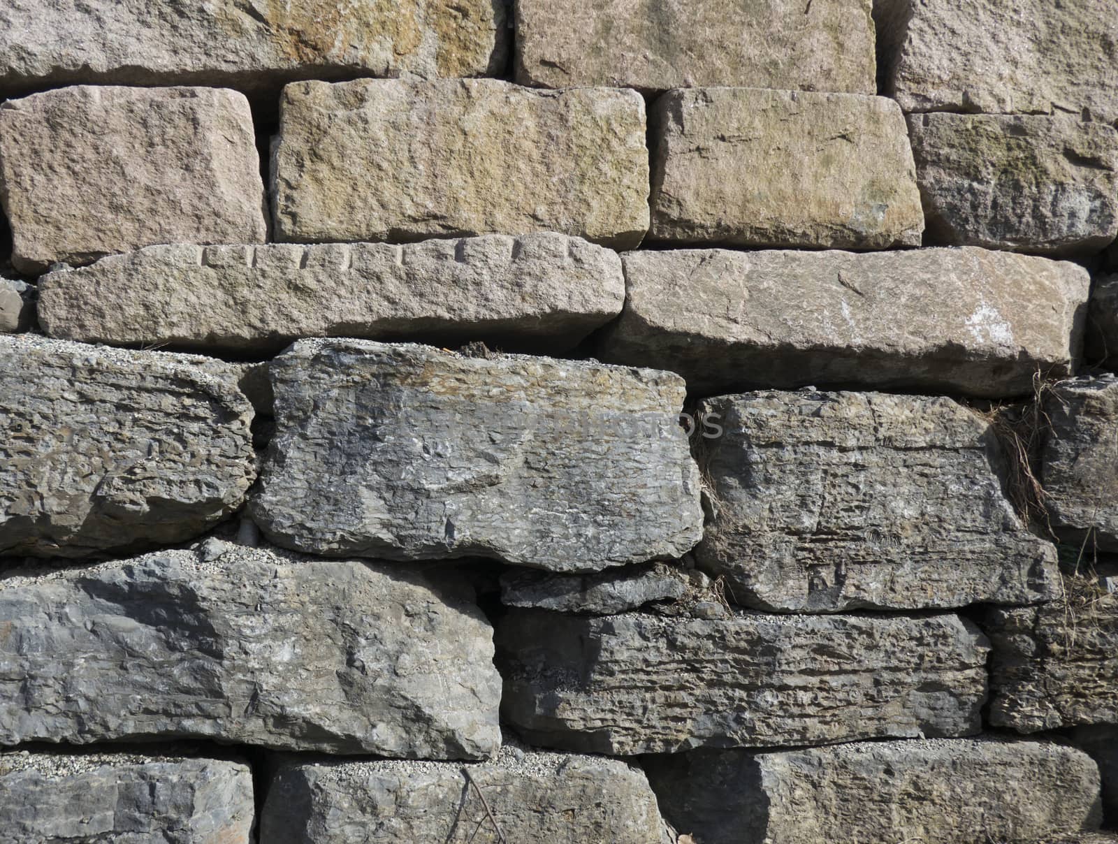 stone wall background with grey and golden stones