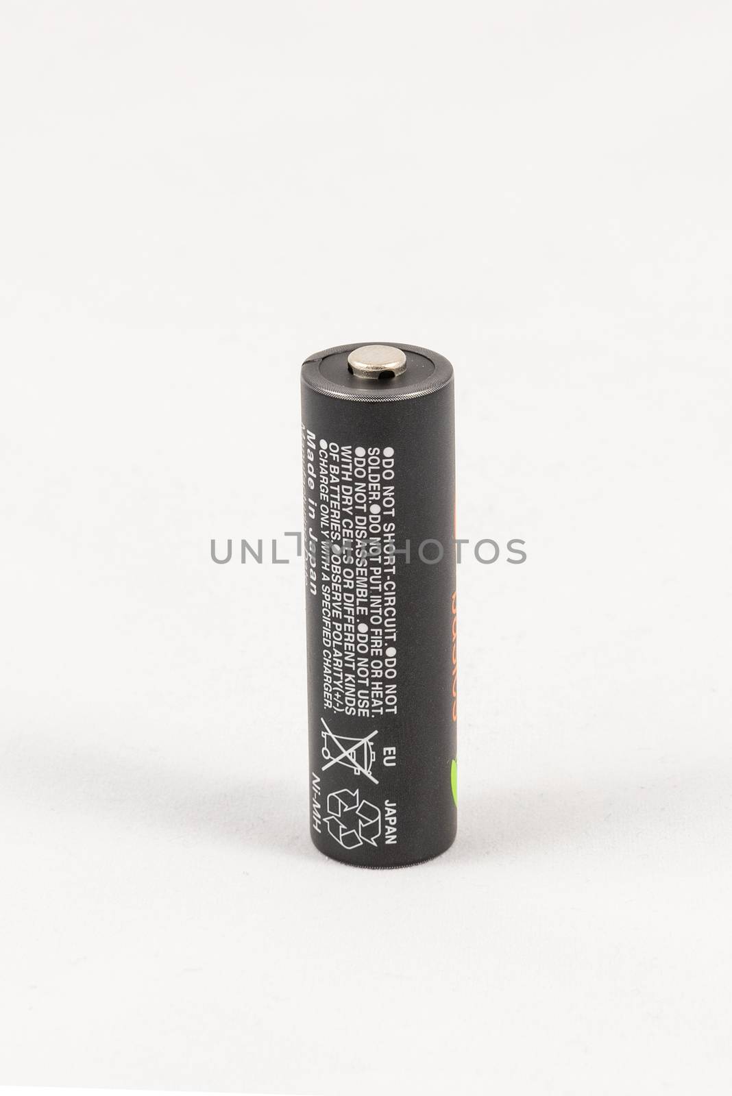Single unbranded black AA rechargeable battery, isolated on white background