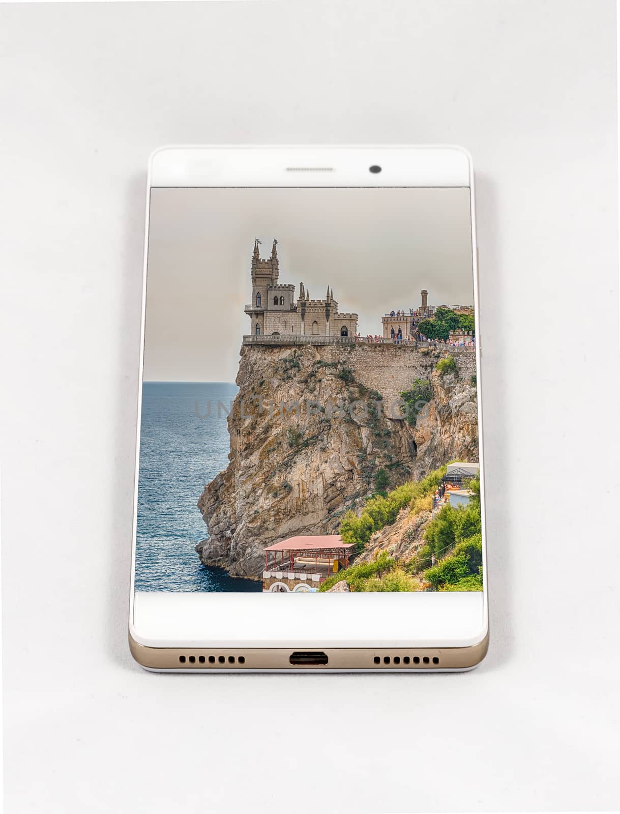 Modern smartphone displaying picture of Swallow's nest, scenic castle over the Black Sea, Yalta, Crimea. Concept for travel smartphone photography. All images in this composition are made by me and separately available on my portfolio