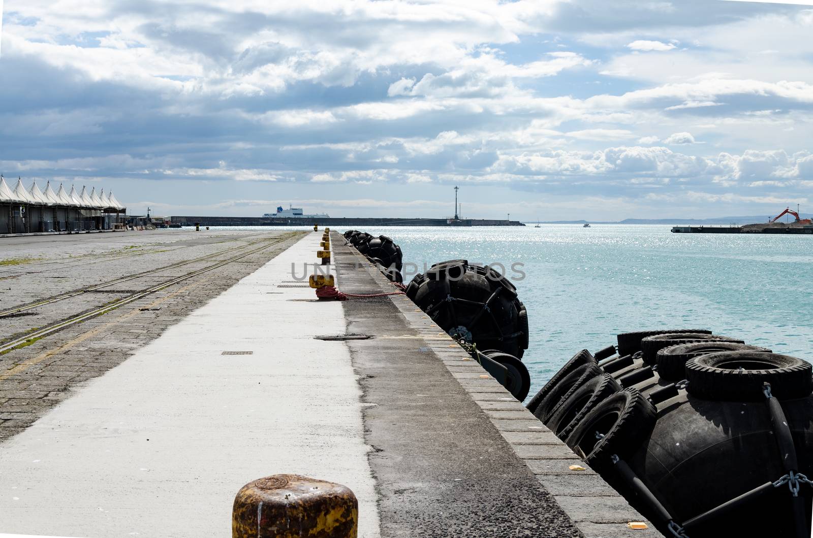 Blacks fenders spherical seats on the edge of a quay to the boats protection