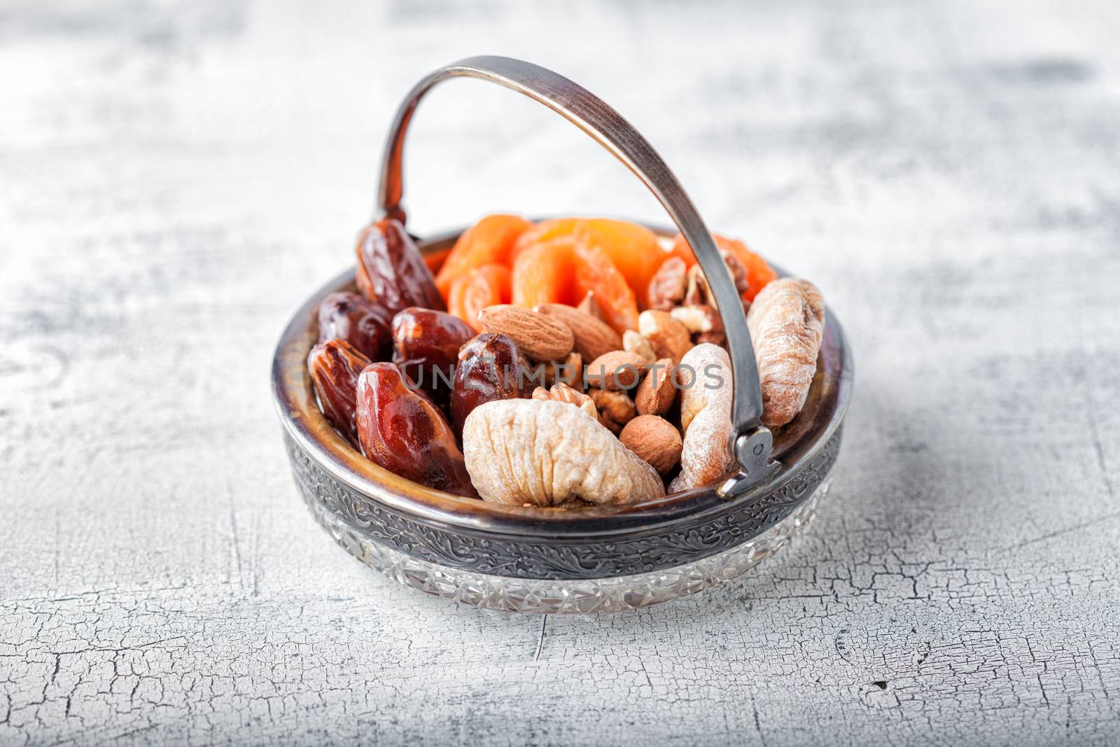 Mixture of dried fruits and nuts on a wooden surface