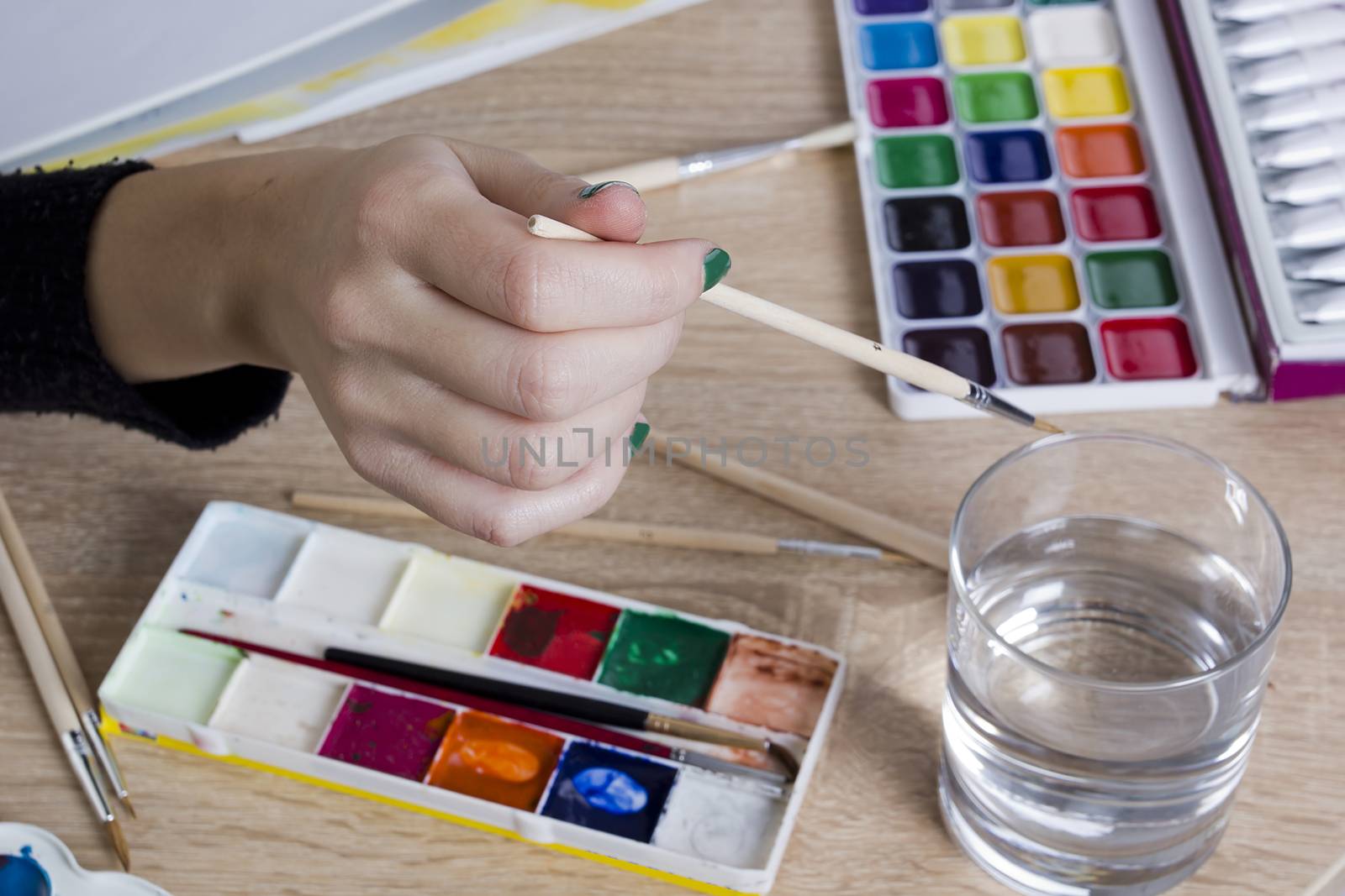 Artist with brushes for drawing and accessories for drawing