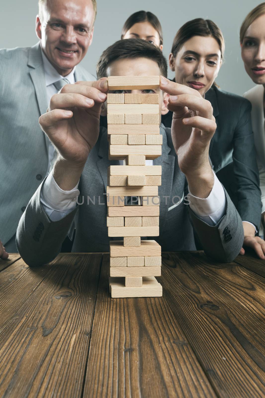 Business people team building wood puzzle tower