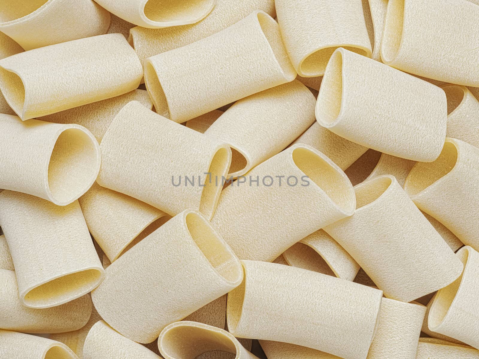 dried italian paccheri tube pasta food background by zkruger