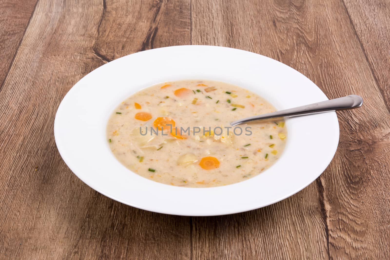 Vegetarian vegetable soup on a wooden table