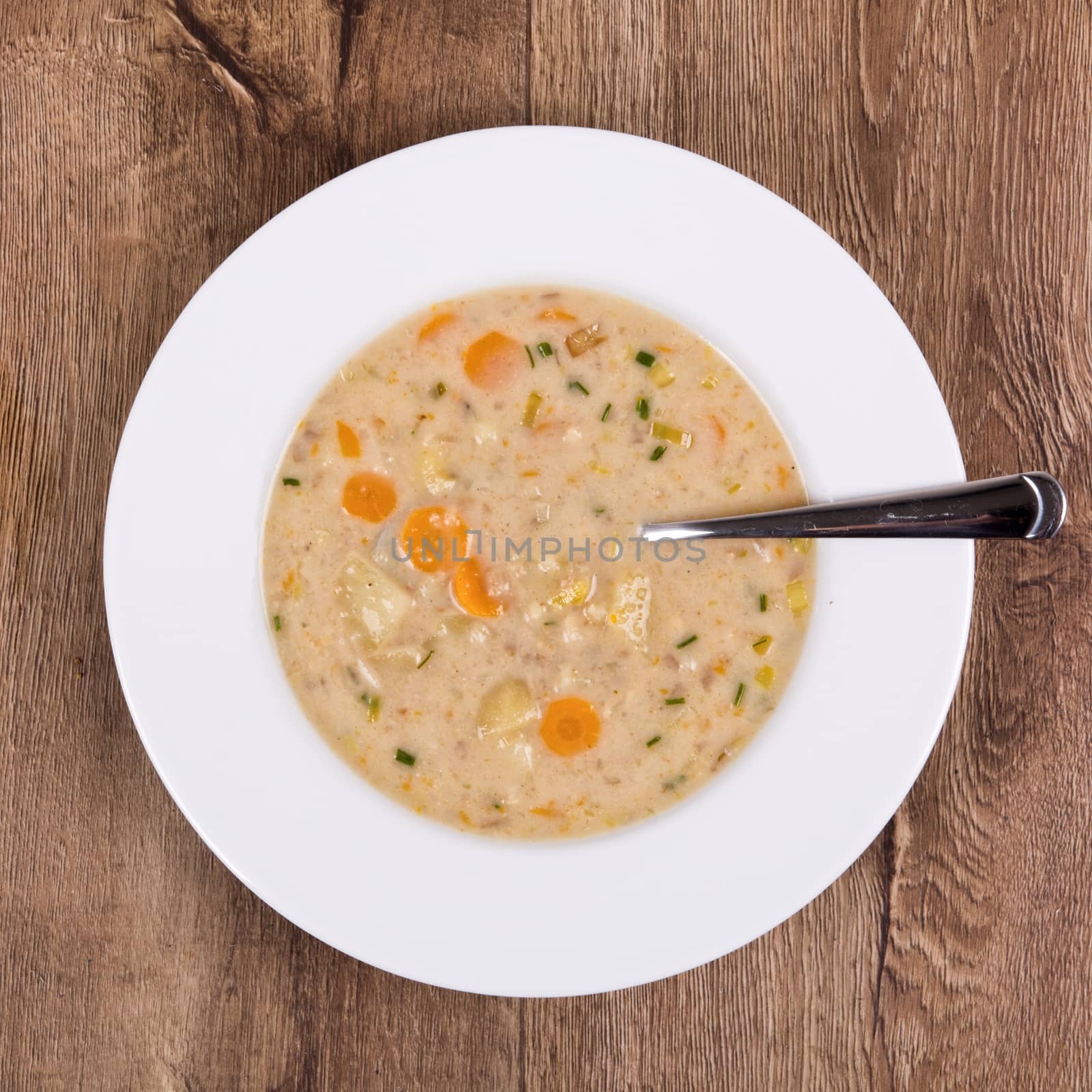 Vegetarian vegetable soup on a wooden table