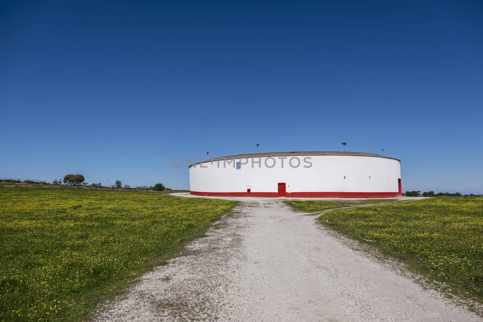 small bullring with red strip and blue sky in Mourao, Alentejo, Portugal
