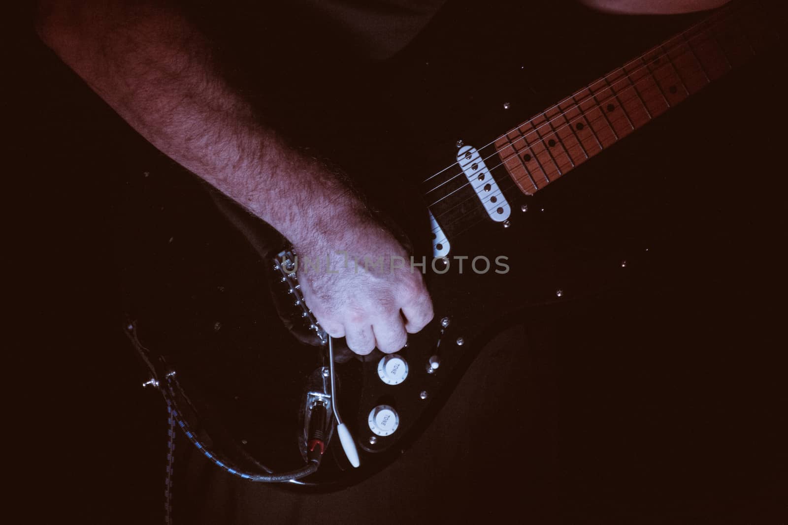 faded colour Close-up  of guitarist playing guitar