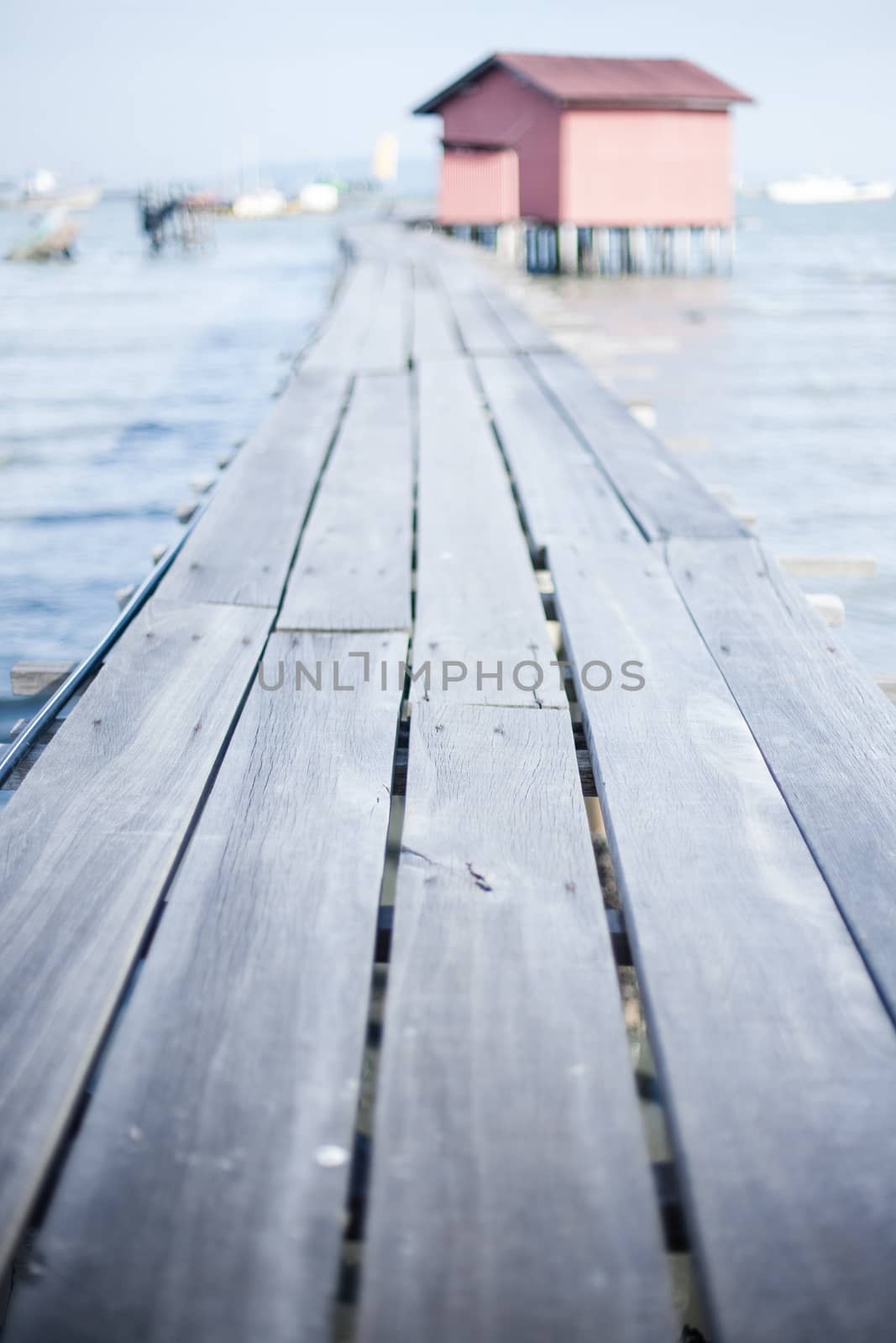 Wooden pier on the sea background, destroyed bridge near tropics. Color panorama