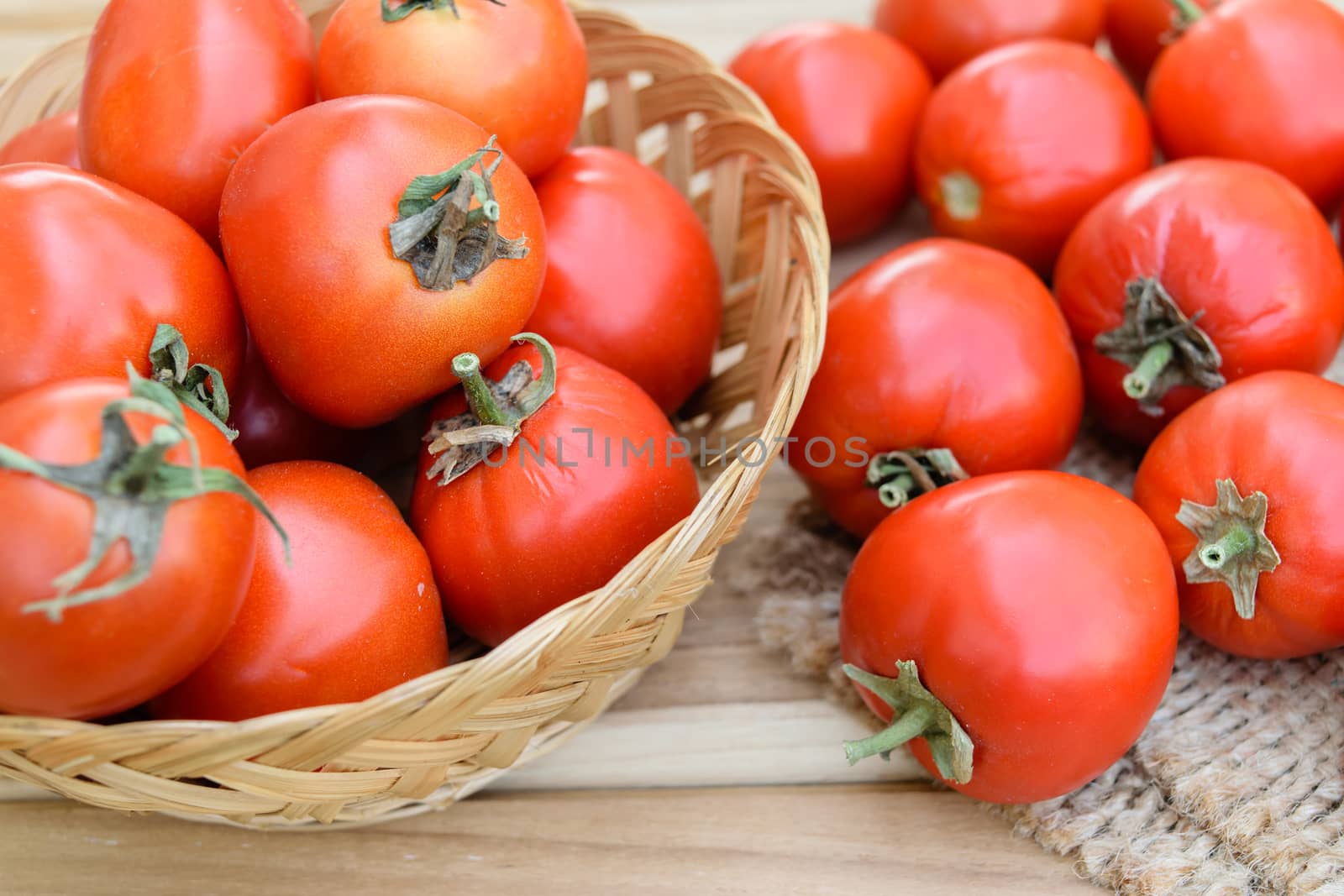 raw tomatoes on wooden table