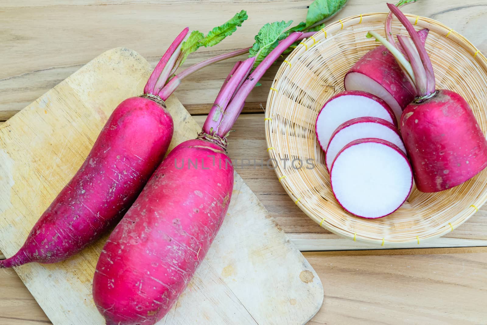 Red radish on wooden table by naramit