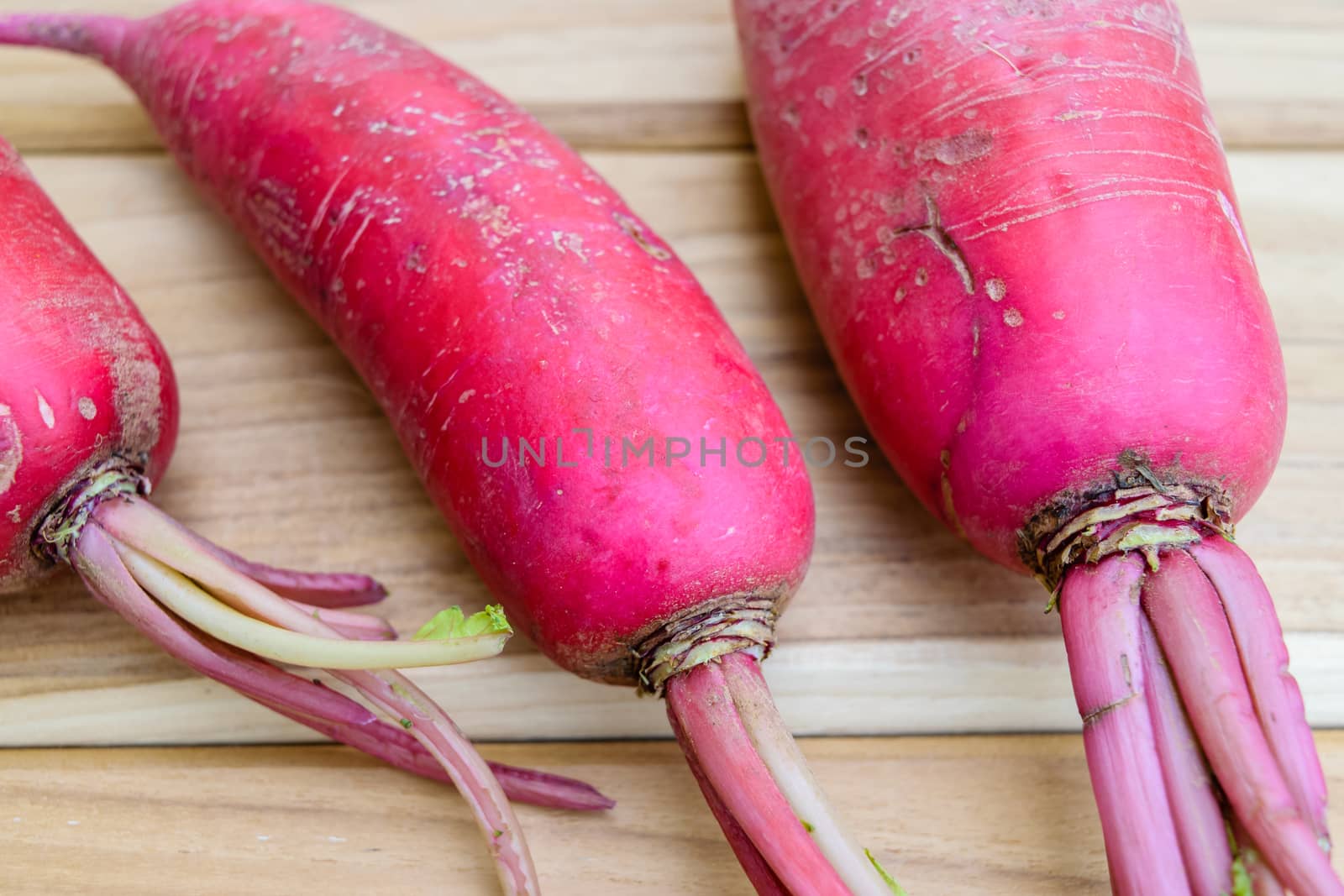 Red radish on wooden table