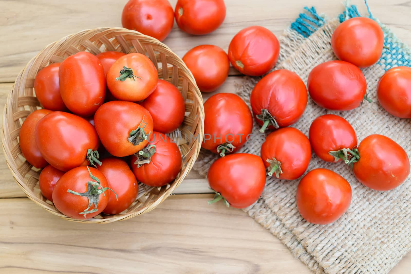 raw tomatoes on wooden table