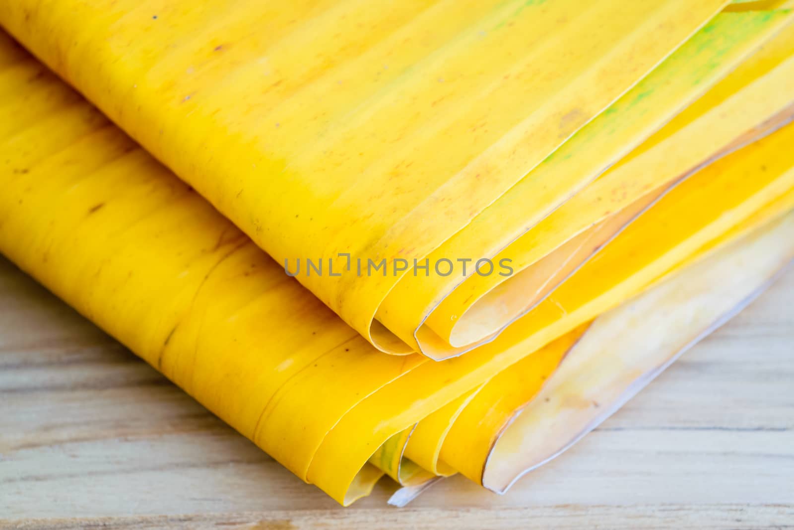 Yellow banana leaf on wooden table