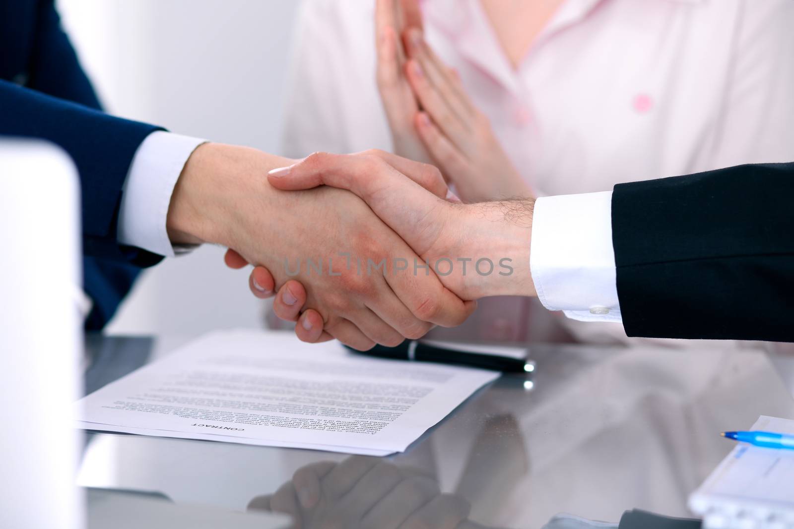 Business people shaking hands finishing up a meeting by Andrei_R