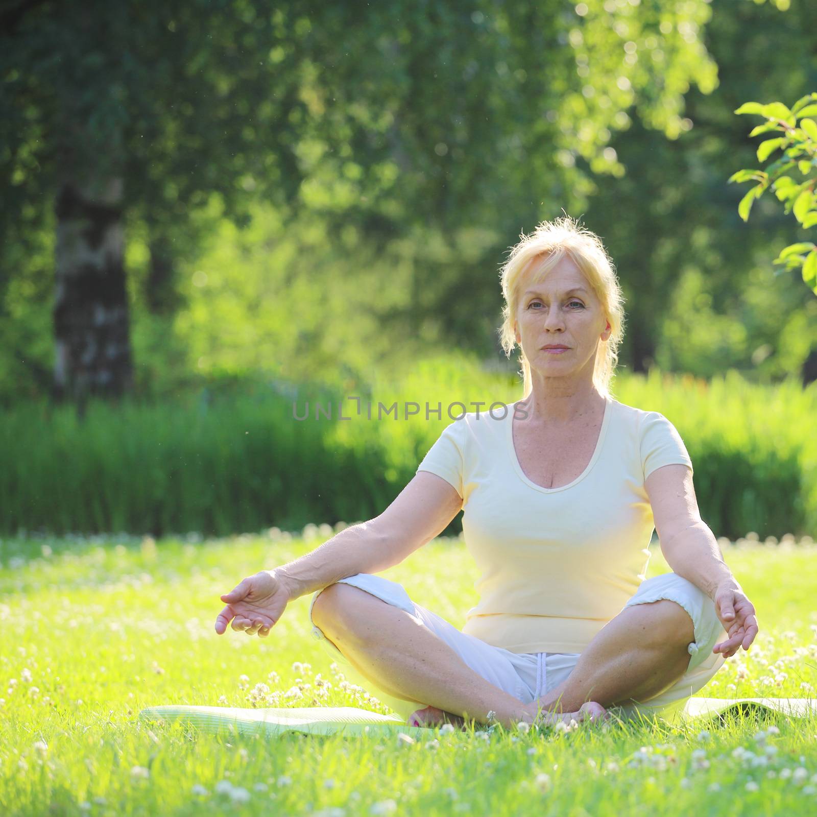 Yoga woman in the park by destillat