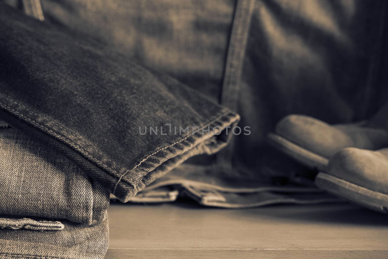 Black of old jeans on wooden floor.