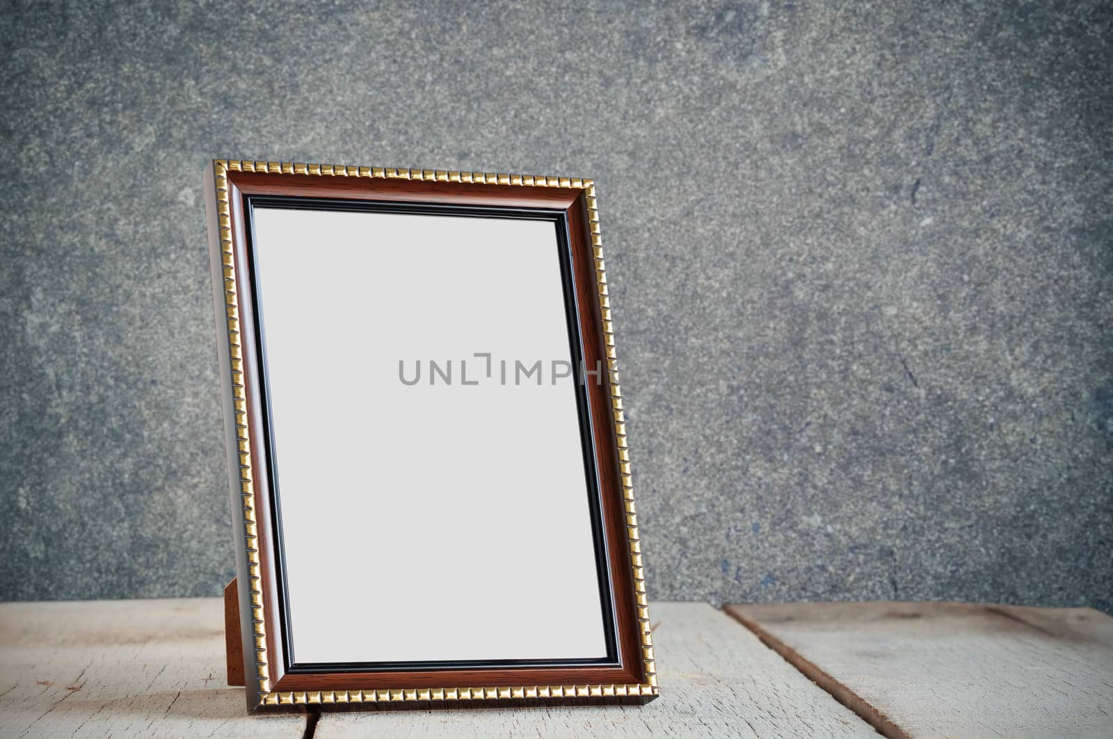 Frame on wooden table. by start08