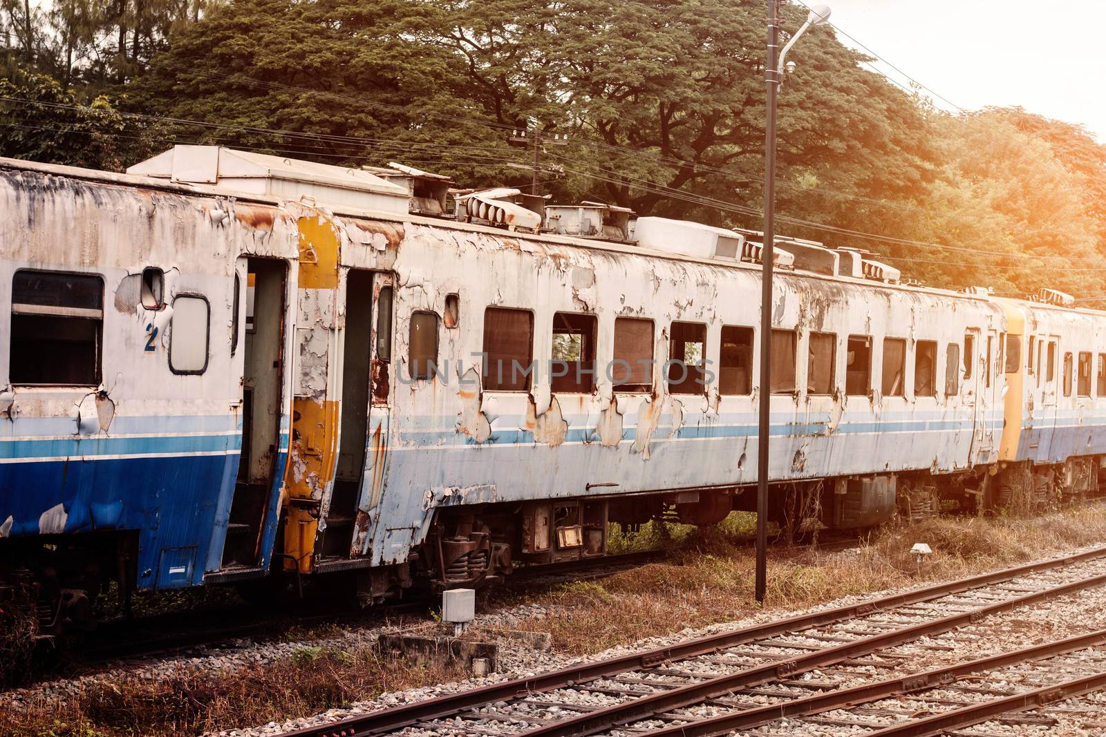 Old and rusty train on tracks in the station.