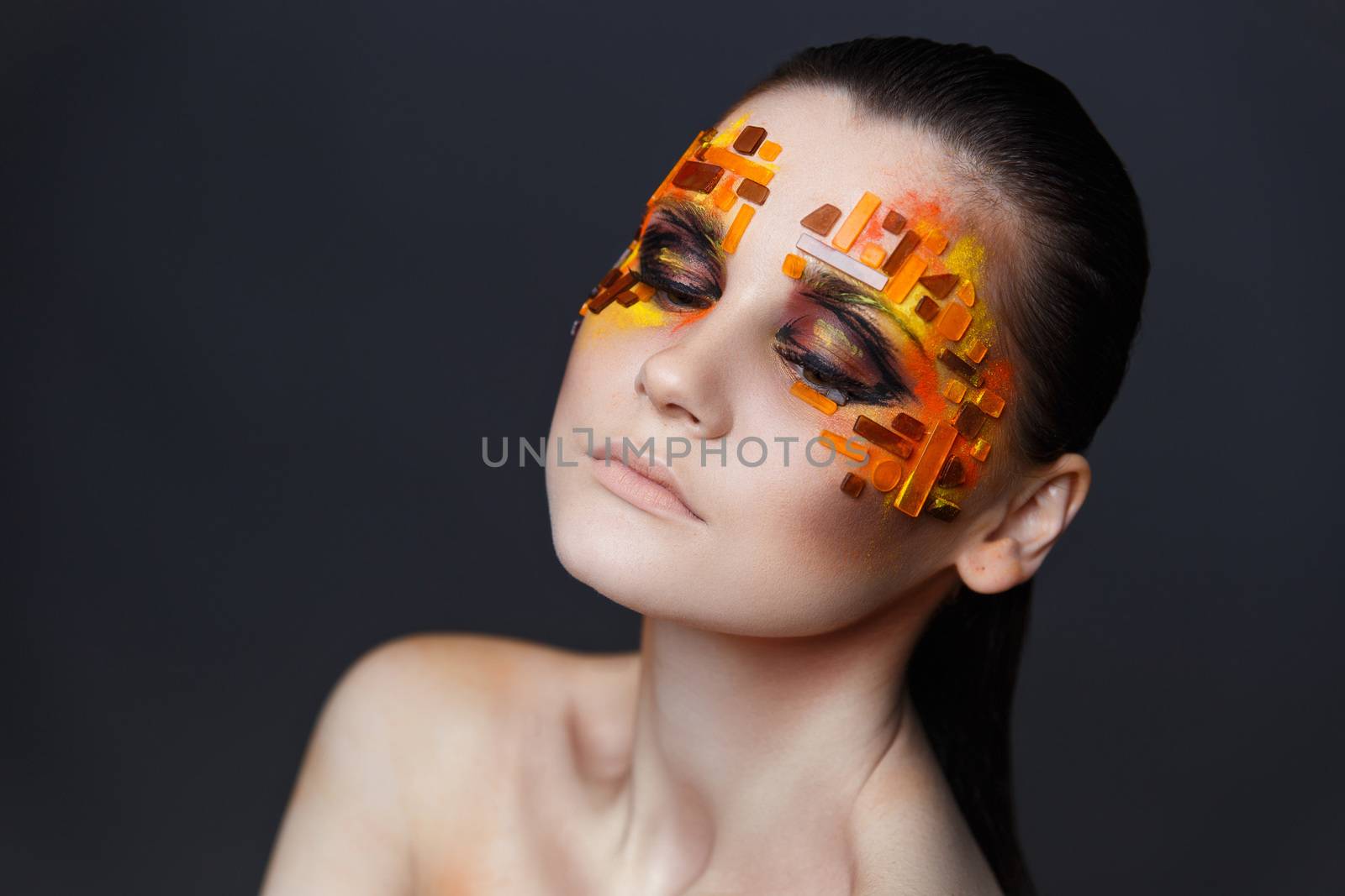 Girl with orange and red rhinestones on her face. by Multipedia