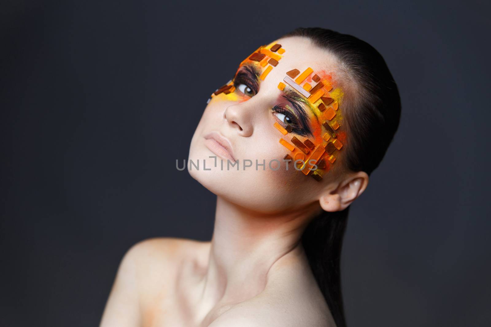 Girl with orange and red rhinestones on her face. by Multipedia