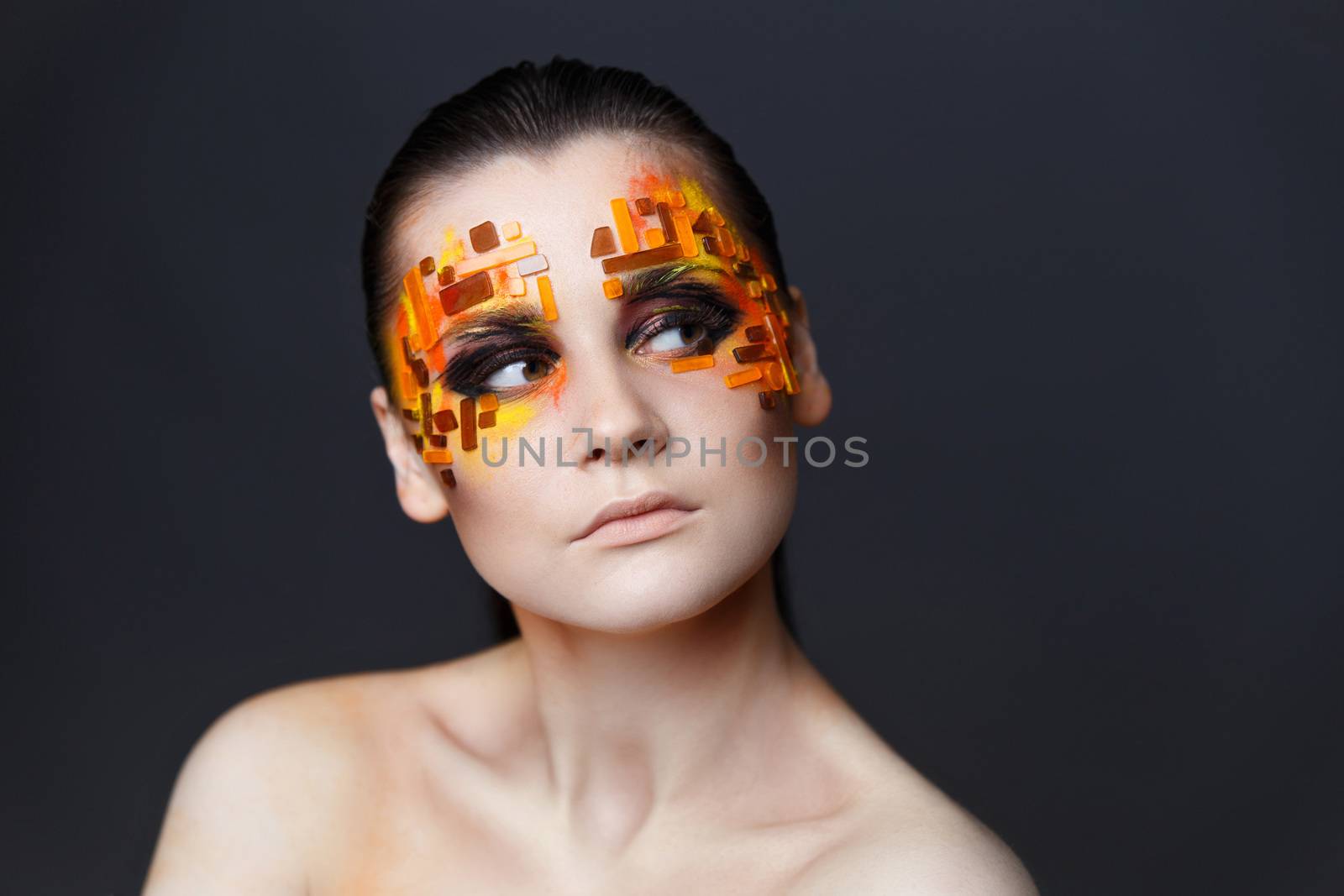 Girl with orange and red rhinestones on her face. by Multipedia