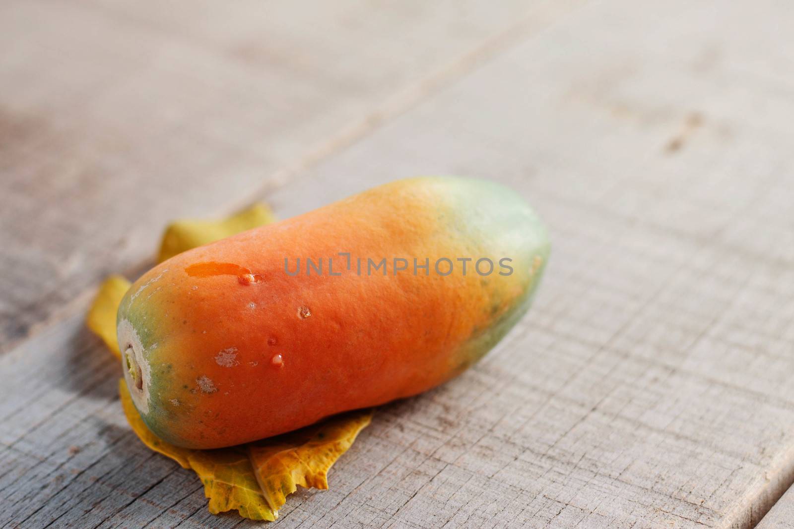 Papaya of ripe on the old wooden floor.