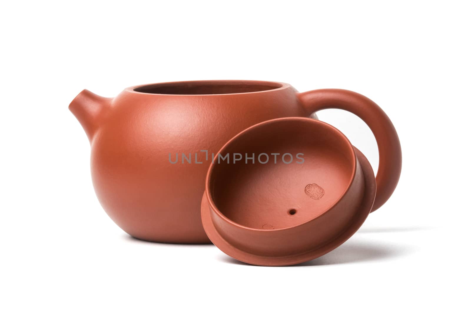 Small brown earthenware teapot with opened lid isolated on white background