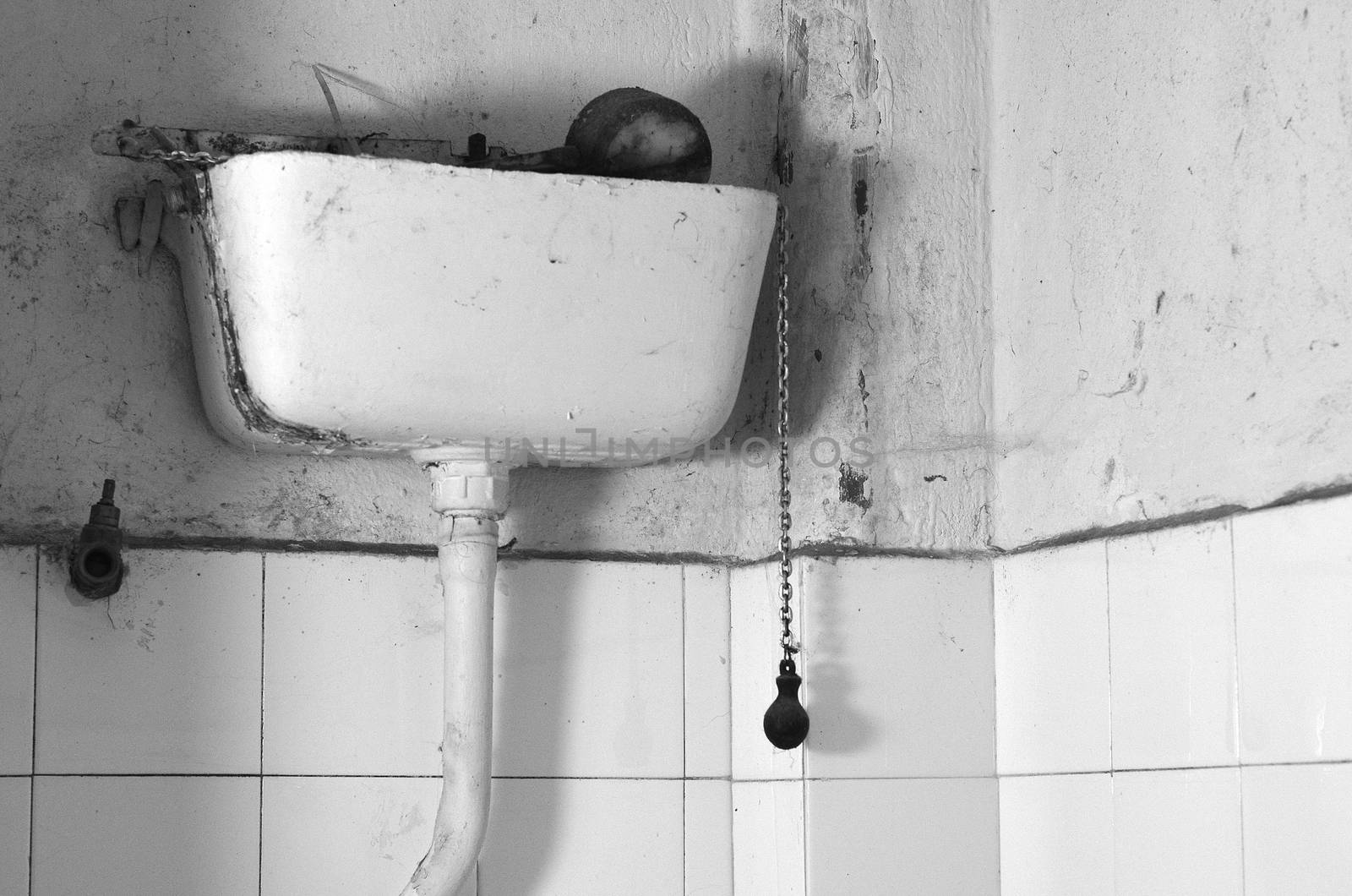 Dirty old flush toilet mechanism black and white theme