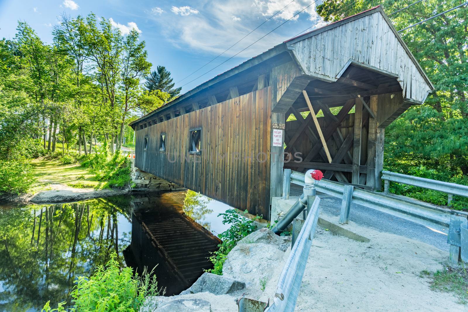 The Waterloo Covered Bridge carries Newmarket Road over the Warner River near the Waterloo Falls in Warner, New Hampshire. The Town lattice truss bridge was built in 1859-60.