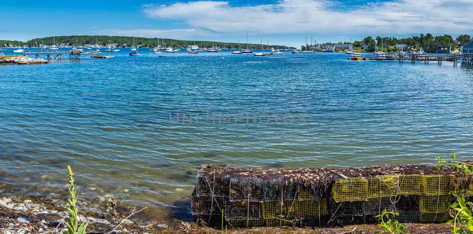 Lobster traps wait along the shore of West Boothbay Harbor at Cape Newagen on the coast of Maine.