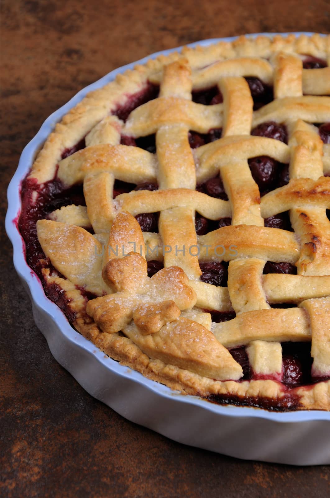 cherry pie dough with decorative ornaments in  roasting pan close-up