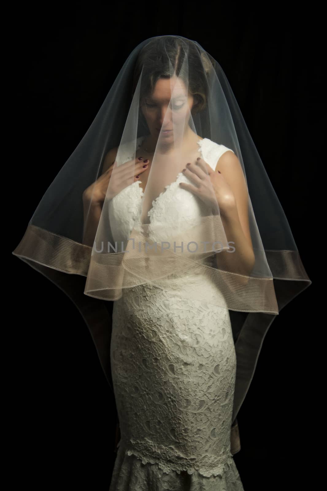 Portrait of a beautiful girl in image of the bride. Photo shot in the Studio on a black background