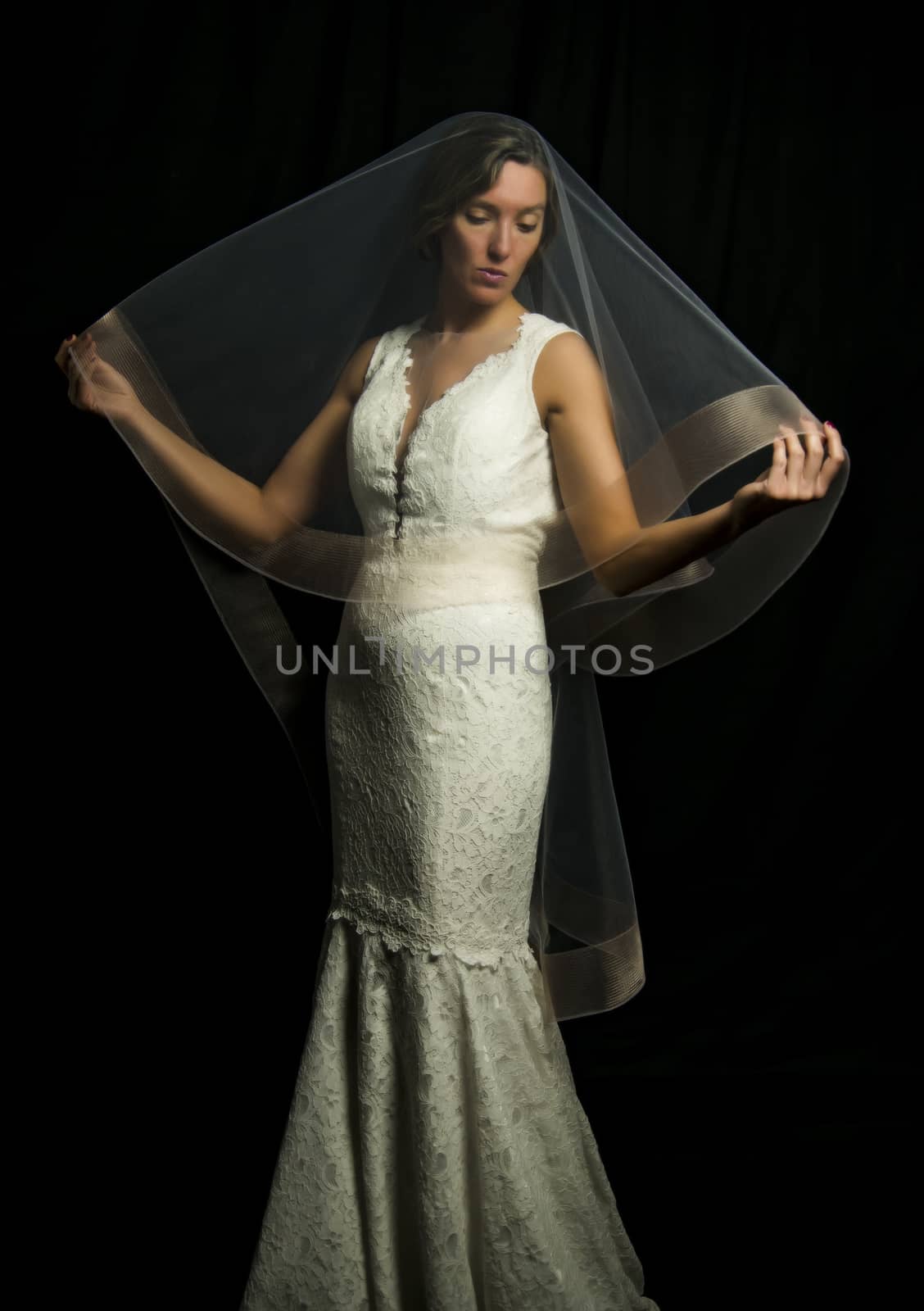 Portrait of a beautiful girl in image of the bride. Photo shot in the Studio on a black background