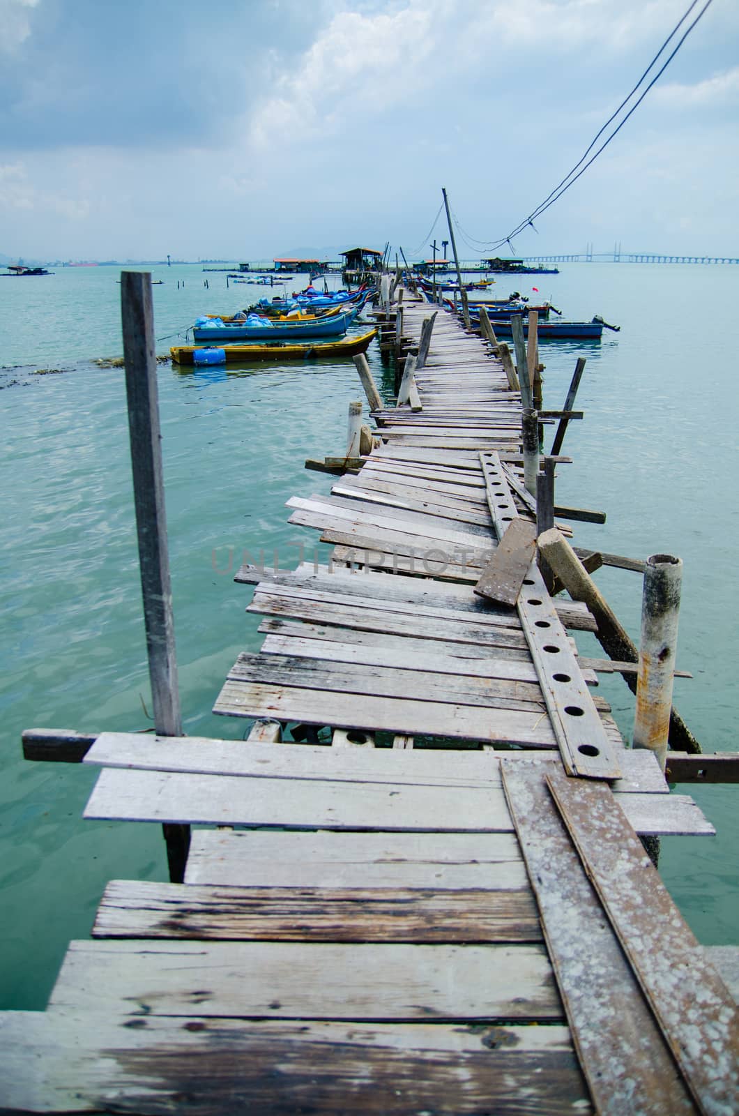 Wooden pier on the sea background, destroyed bridge near tropics. Color panorama