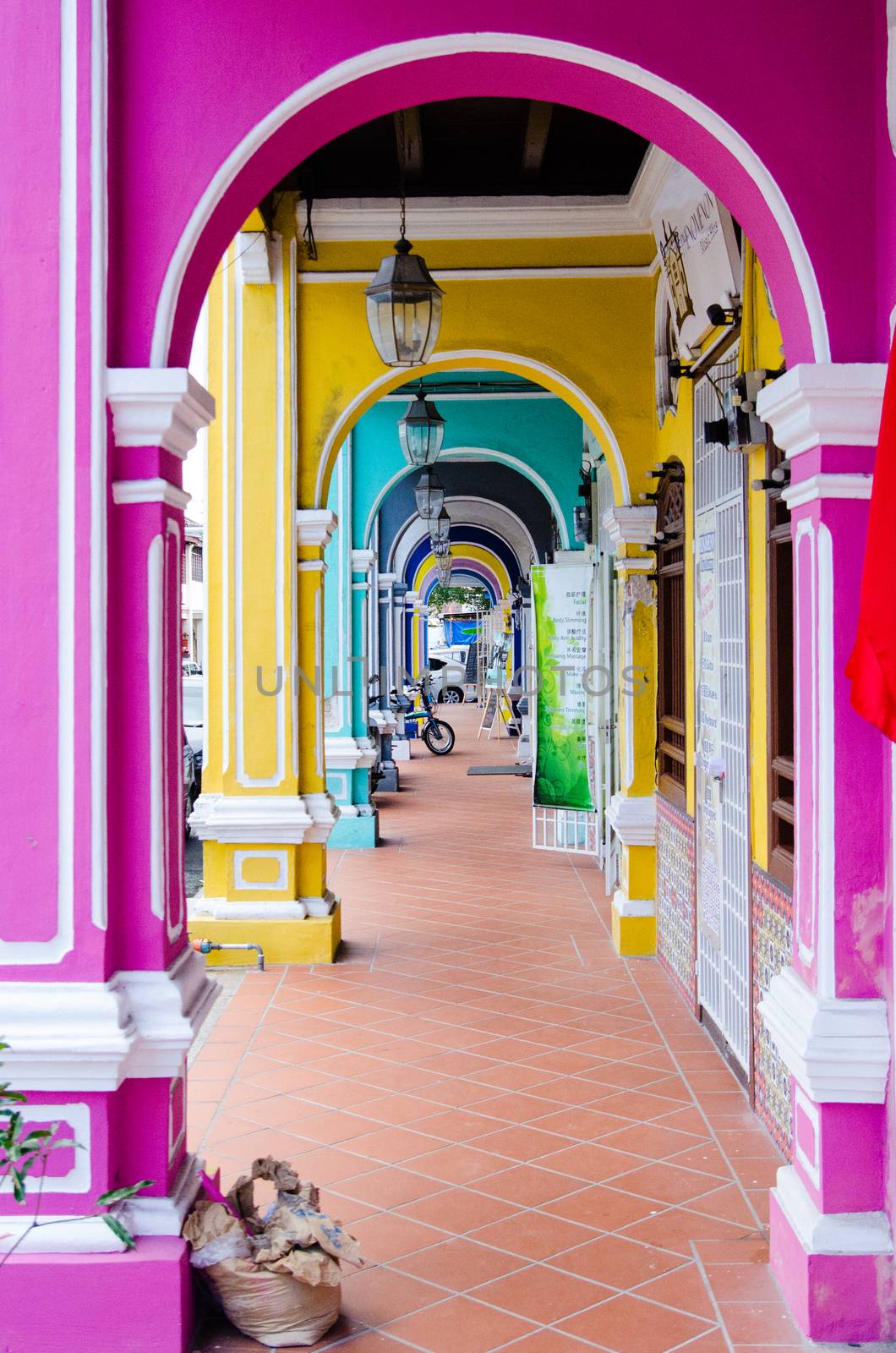 Penang, Malaysia. Color architecture narrow streets with people. Dirty moldy humidity cityscape