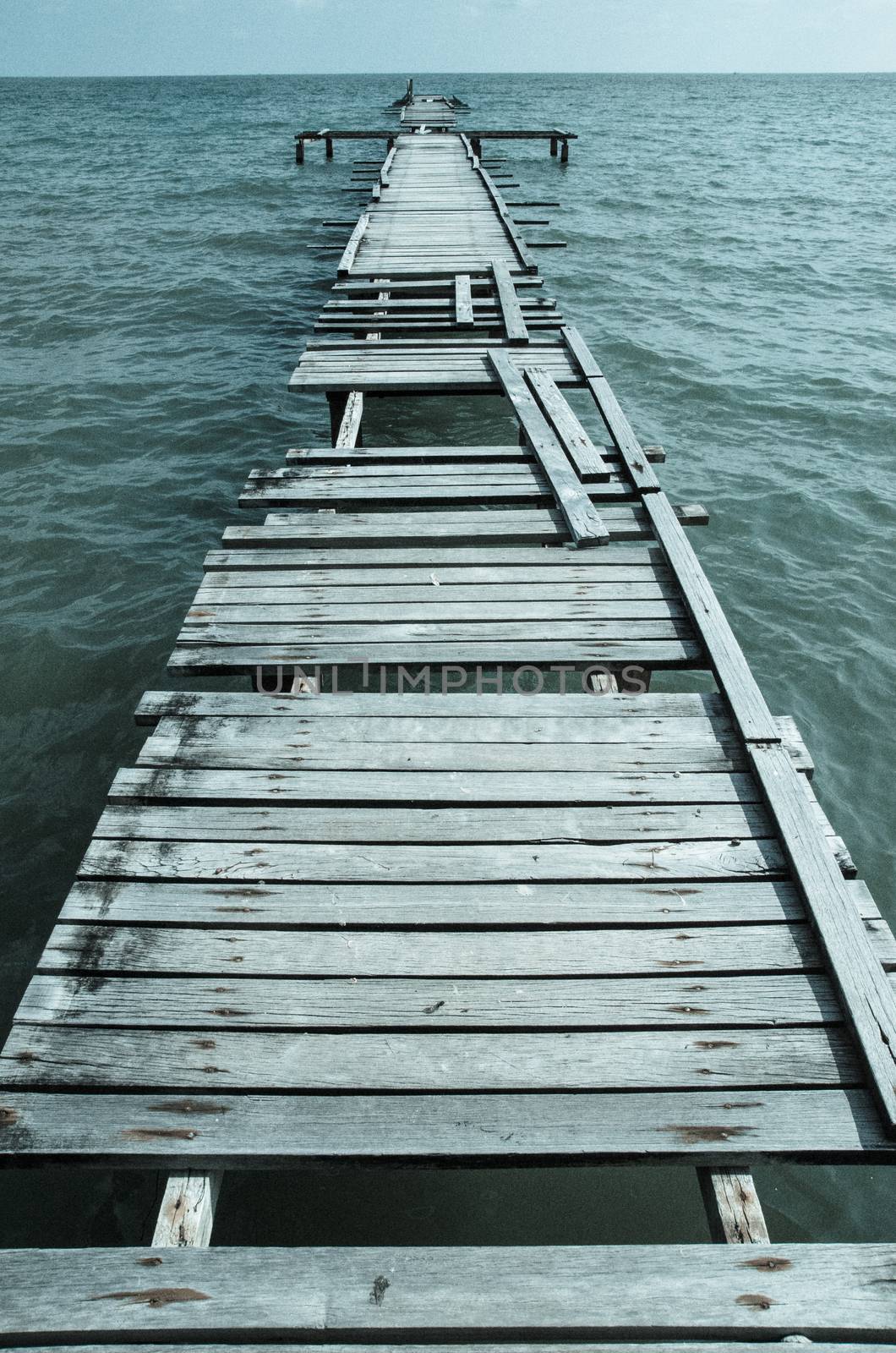 Penang island Malaysia. Wooden pier on the sea background, destroyed bridge near tropics. Color panorama