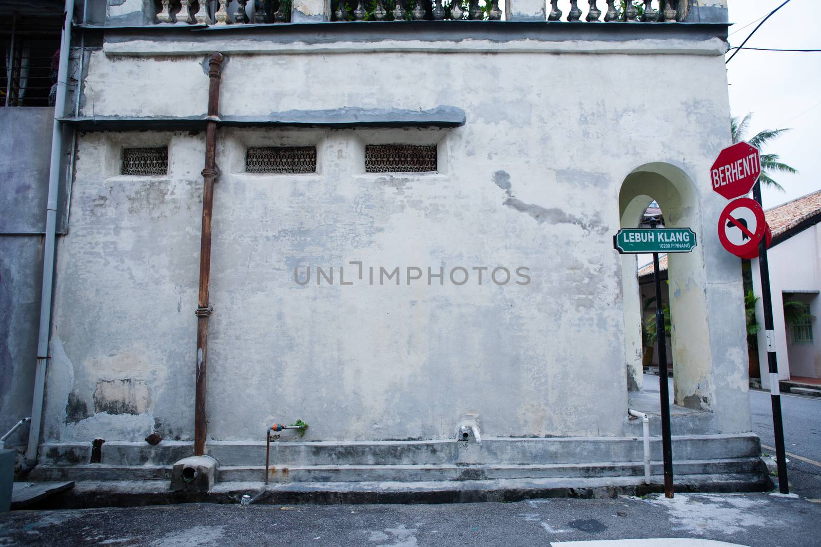 Penang, Malaysia architecture narrow streets. Dirty moldy humidity wall on cityscape