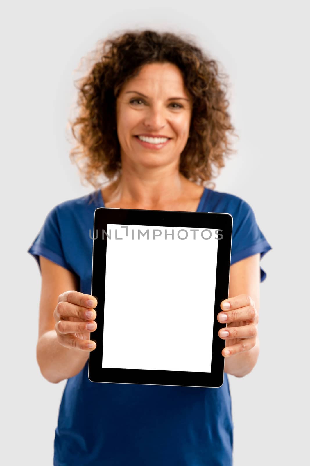 Happy woman holding tablet by Iko