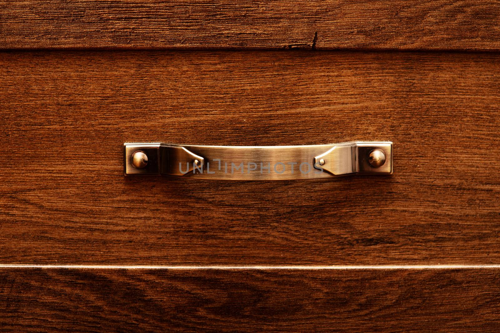 detail of decorated furniture drawers. old drawer - damper. Close-up detail of high quality Oak wood cabinets with bronze cabinet hardware drawer pulls