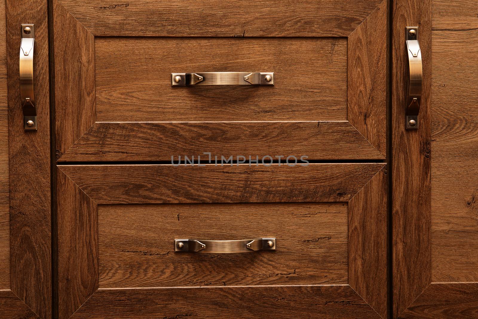 detail of decorated furniture drawers. old drawer - damper. Close-up detail of high quality Oak wood cabinets with bronze cabinet hardware drawer pulls