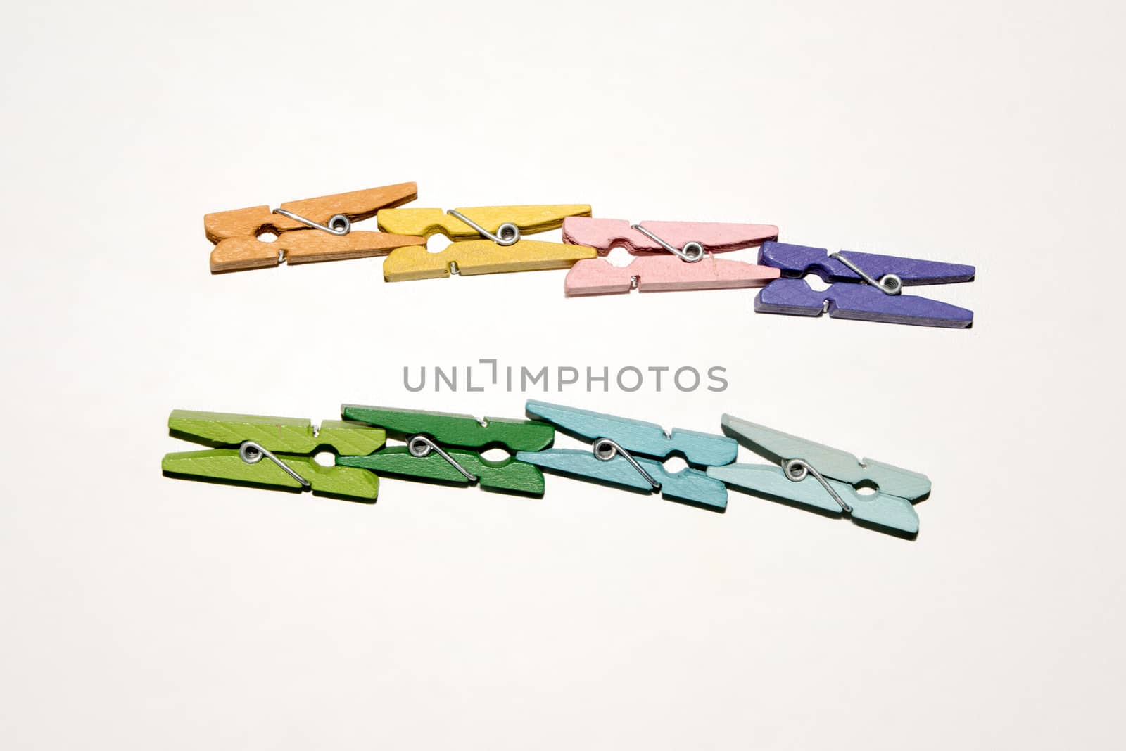 Colorful wooden clothespin. Background of colorful clothes pegs. Closeup of colorful clothespins.

