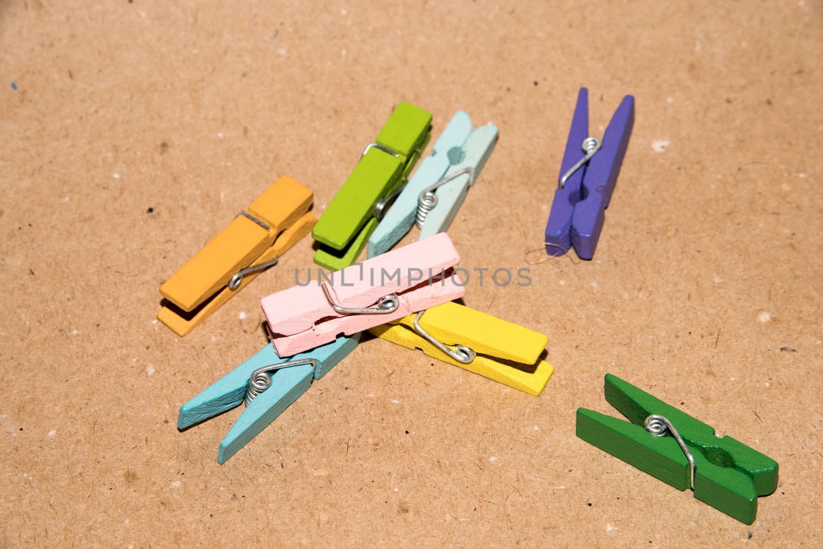 Colorful wooden clothespin. Background of colorful clothes pegs. Closeup of colorful clothespins.

