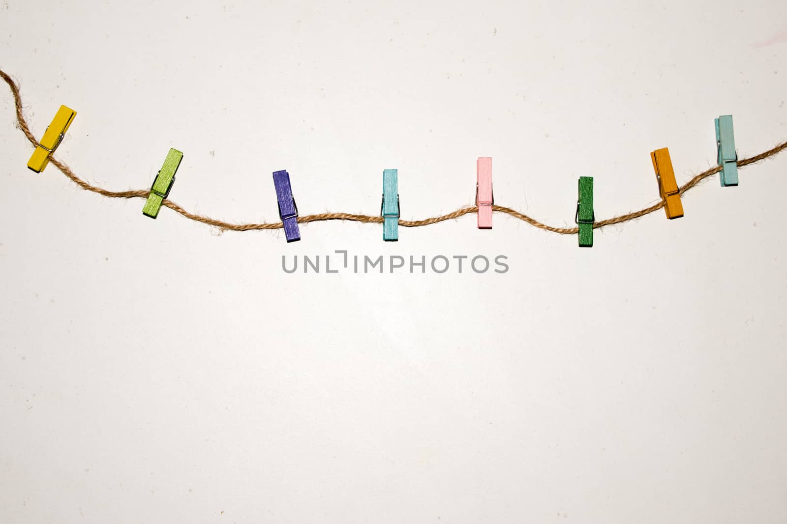 Colorful wooden clothespin. Background of colorful clothes pegs. Closeup of colorful clothespins.

