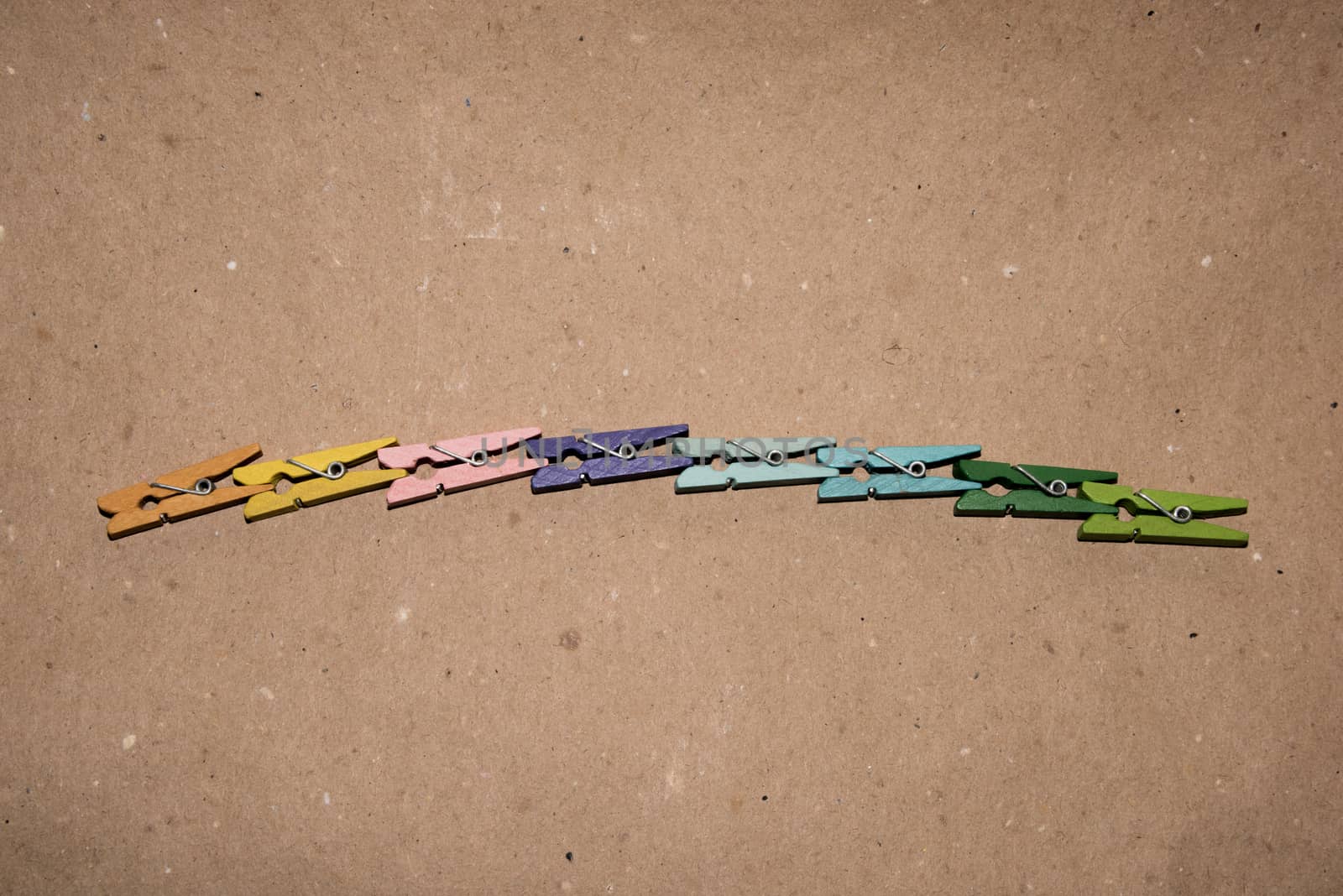 Colorful wooden clothespin. Background of colorful clothes pegs. Closeup of colorful clothespins.

