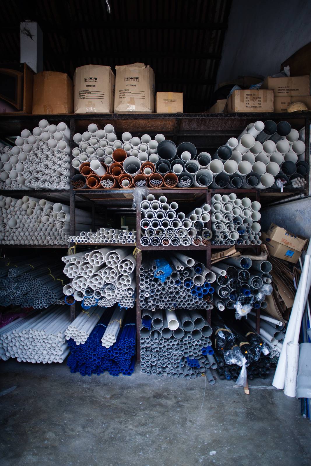 Boxes of grey and white plastic pipes by Vanzyst