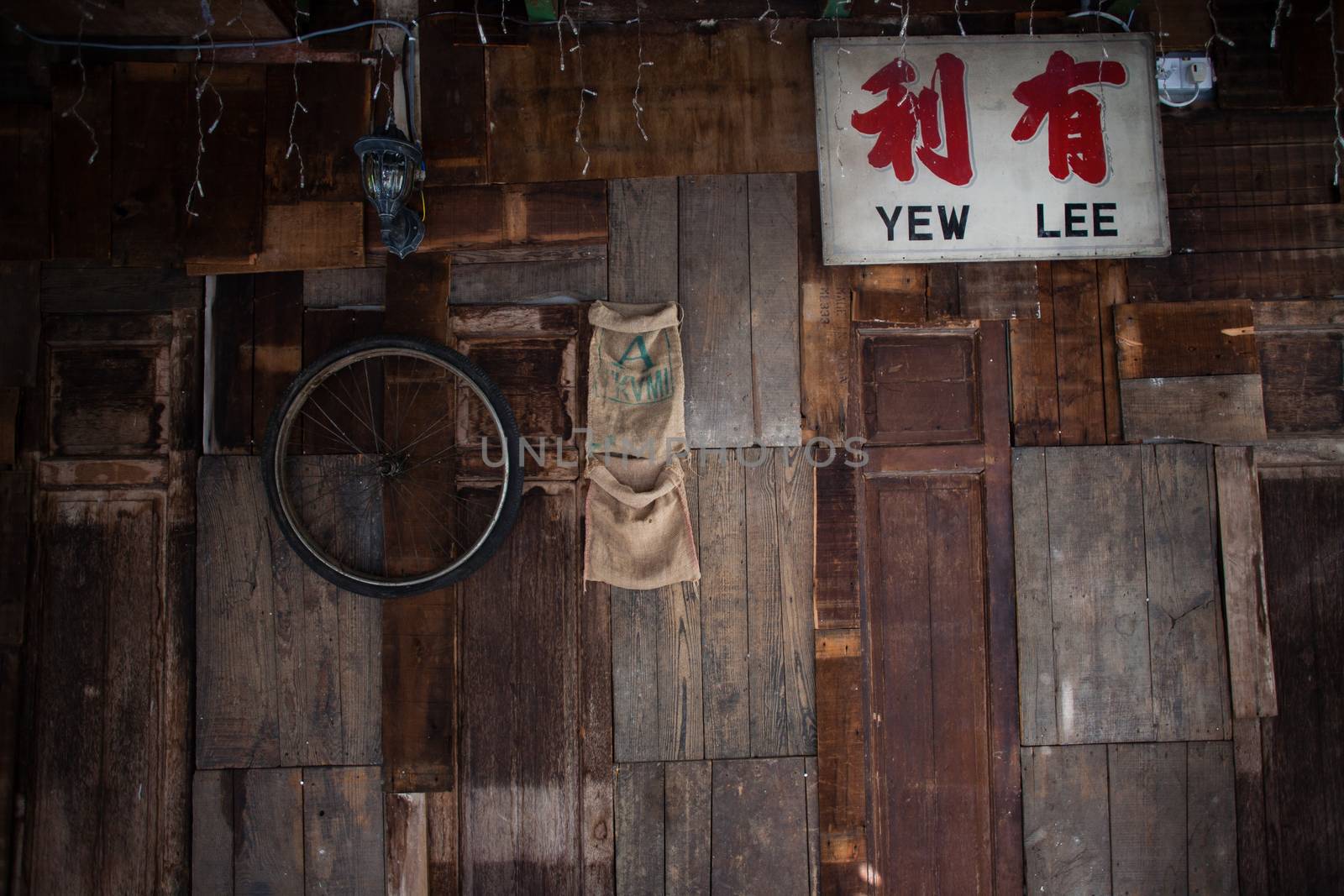 Wall with old wooden boards and boxes in garage